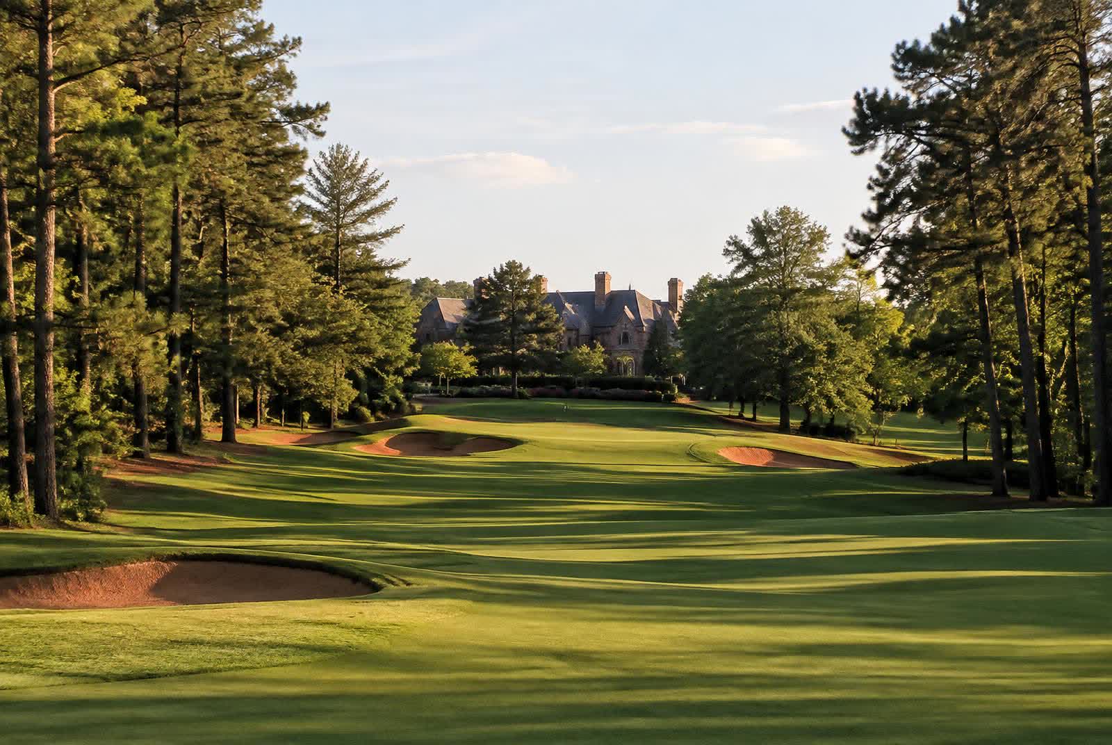 Manicured golf fairway framed by tall pines and hardwoods in the North Carolina Piedmont near Marvin
